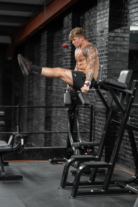 A photo of the coach working out in a gym performing an isometric exercise.